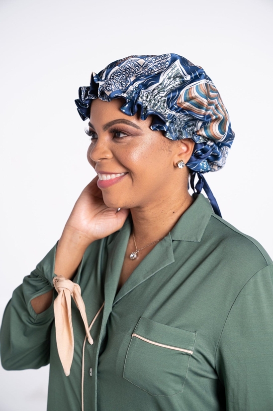 Woman is Rhea Cherie silk bonnet and green modern sleepshirt